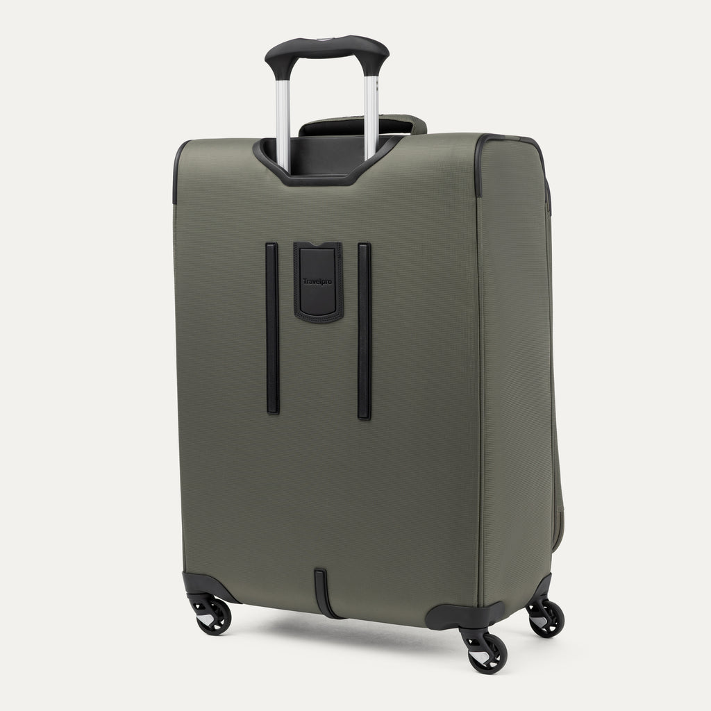Green suitcase with black handle and wheels on a white background