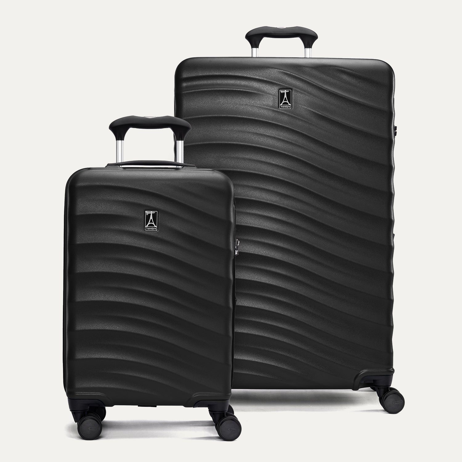 front view of the black travelpro maxlite air v2 set featuring the compact carry-on and large check-in hardside spinners with telescoping handles extended.
