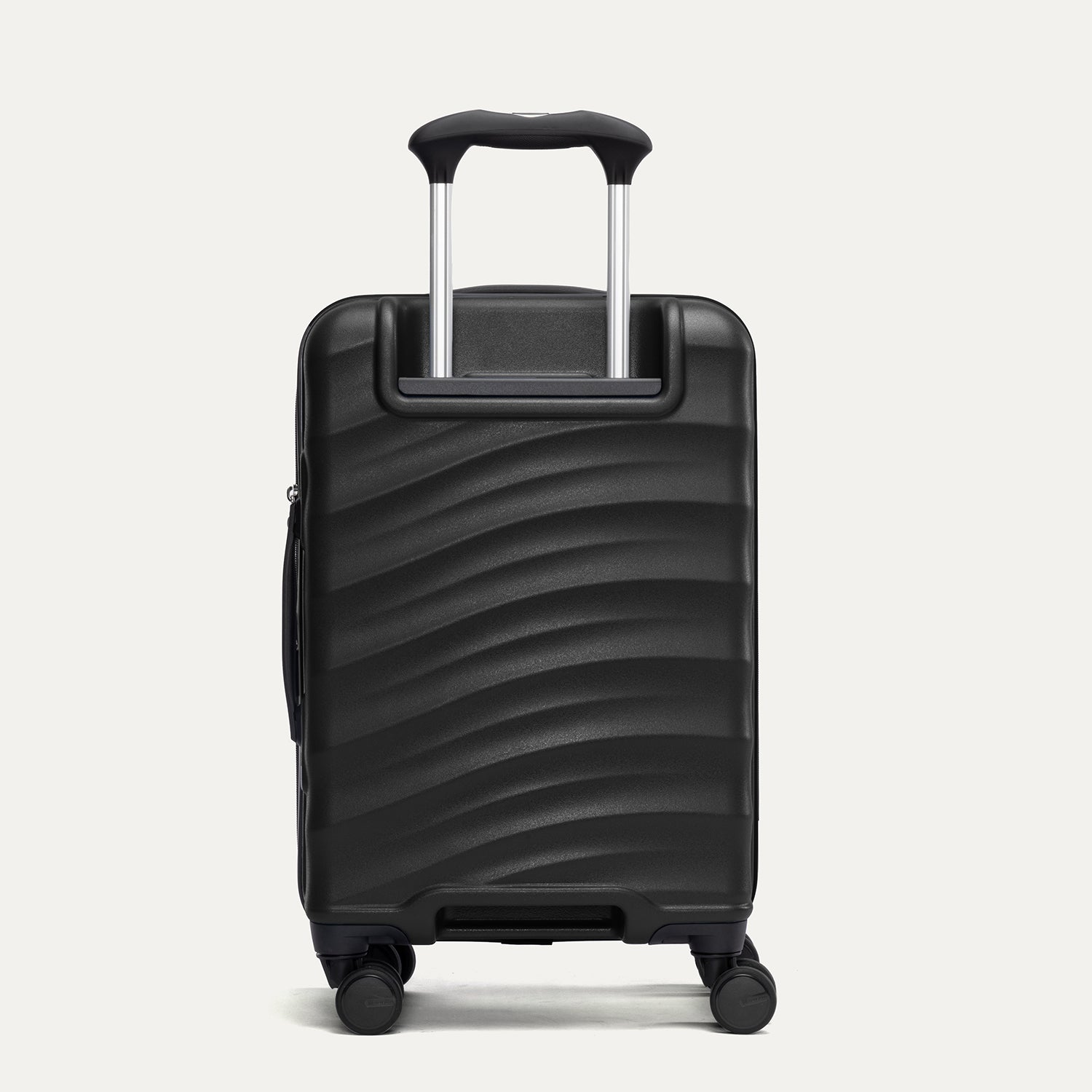 back view of the black travelpro maxlite air v2 hardside spinner showing the textured polycarbonate shell and the powerscope lite telescoping handle.