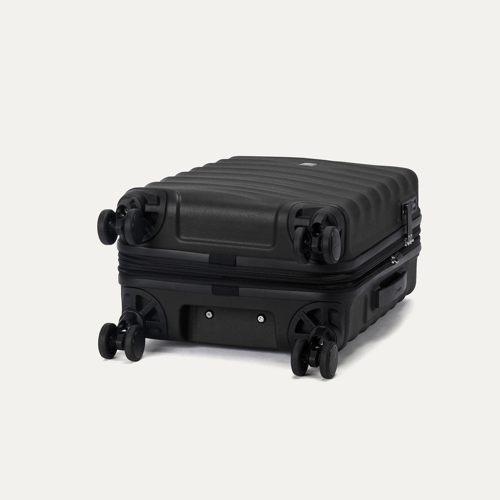 bottom view of the black travelpro maxlite air v2 suitcase showing the four 360 degree spinner wheels and the protective polycarbonate shell.