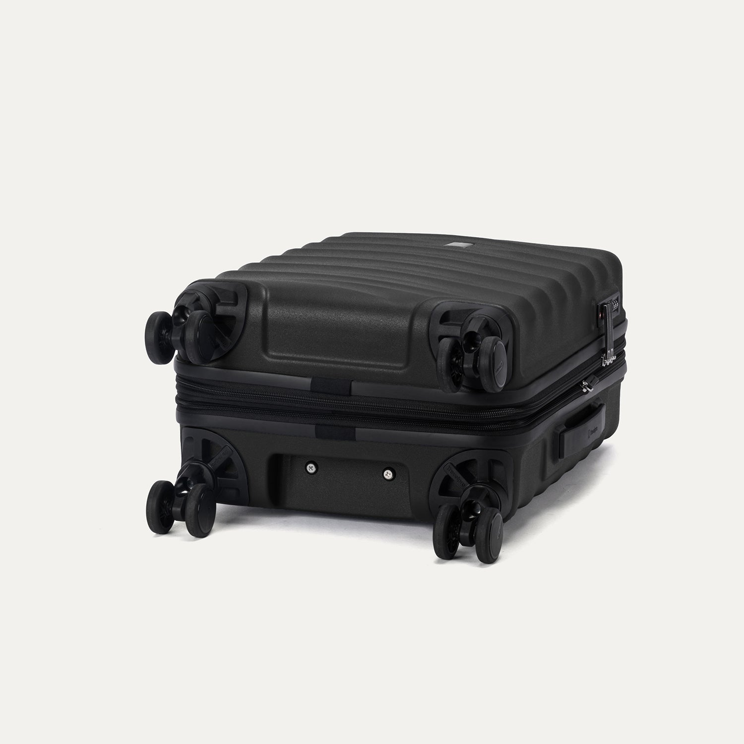 bottom view of the black travelpro maxlite air v2 suitcase showing the four 360 degree spinner wheels and the protective polycarbonate shell.