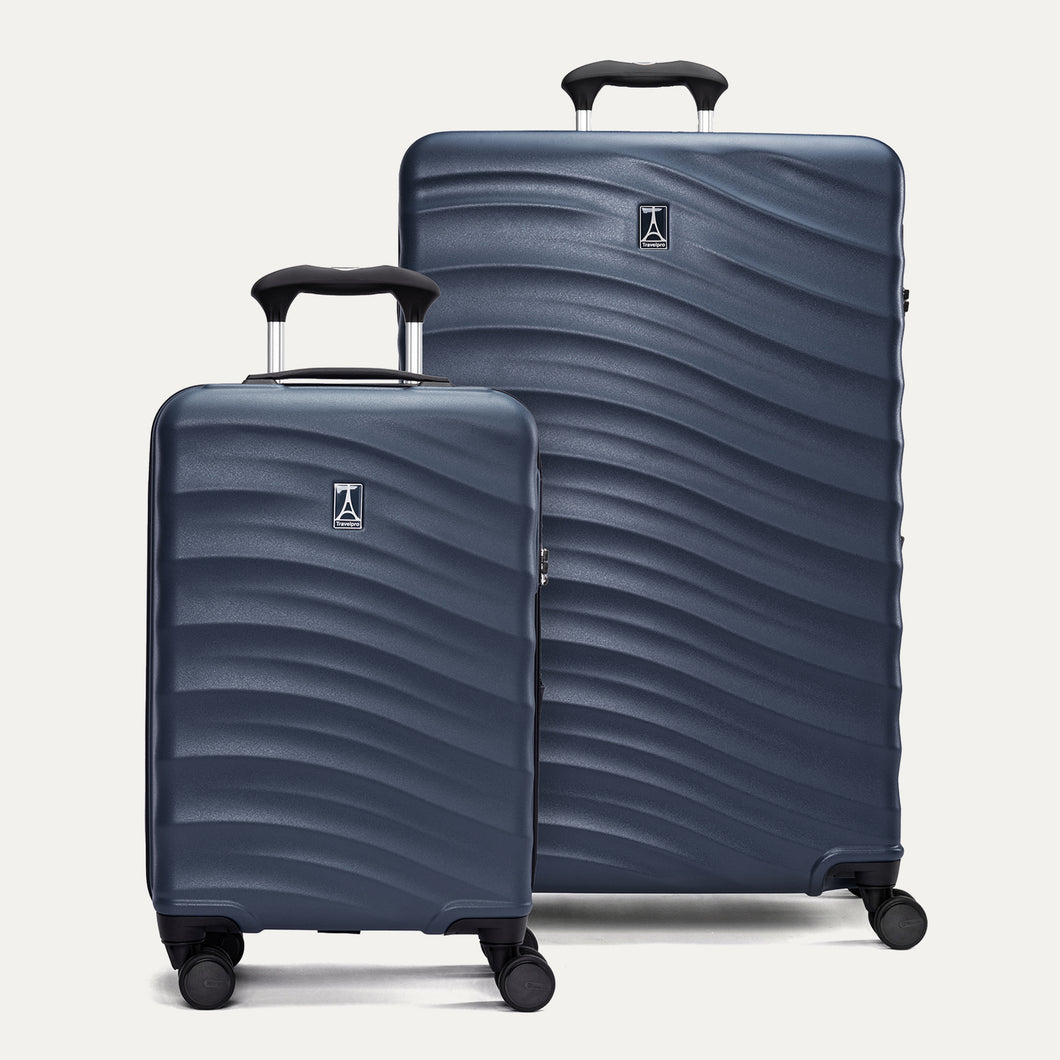 Two dark blue suitcases with a visible brand logo on a light gray background