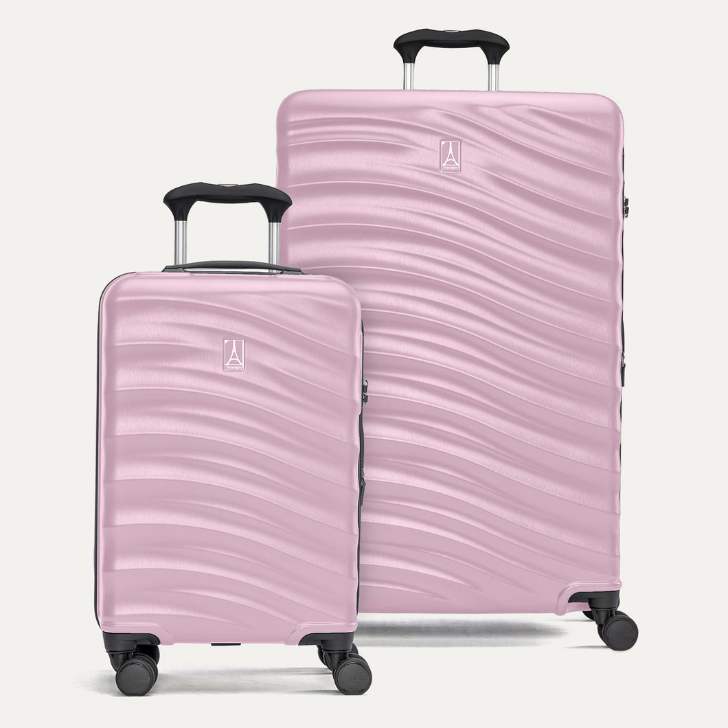 two pink hardside suitcases on a white background