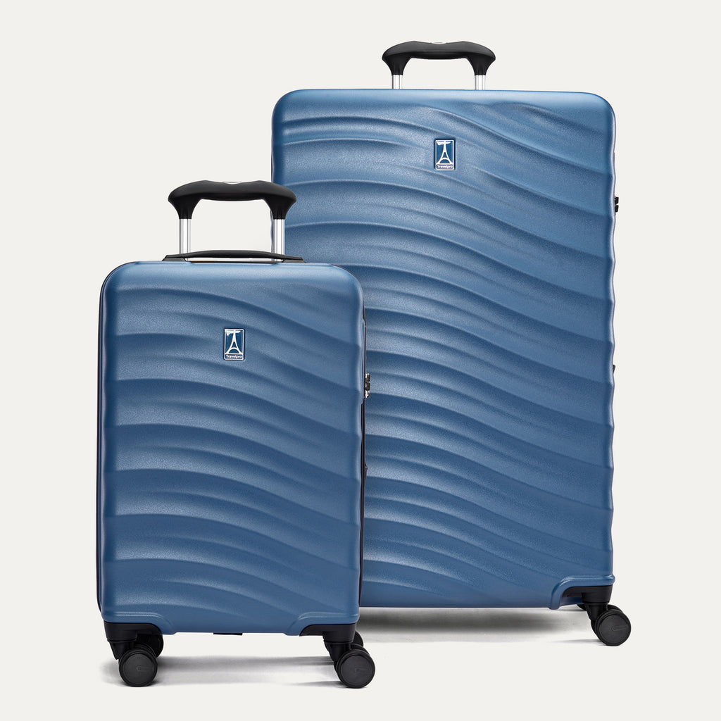 Two blue suitcases with a textured surface on a light gray background