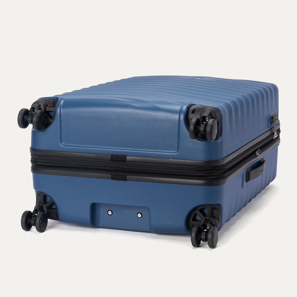 bottom view of the ensign blue travelpro maxlite air v2 suitcase showing the four 360 degree spinner wheels and the protective polycarbonate shell.
