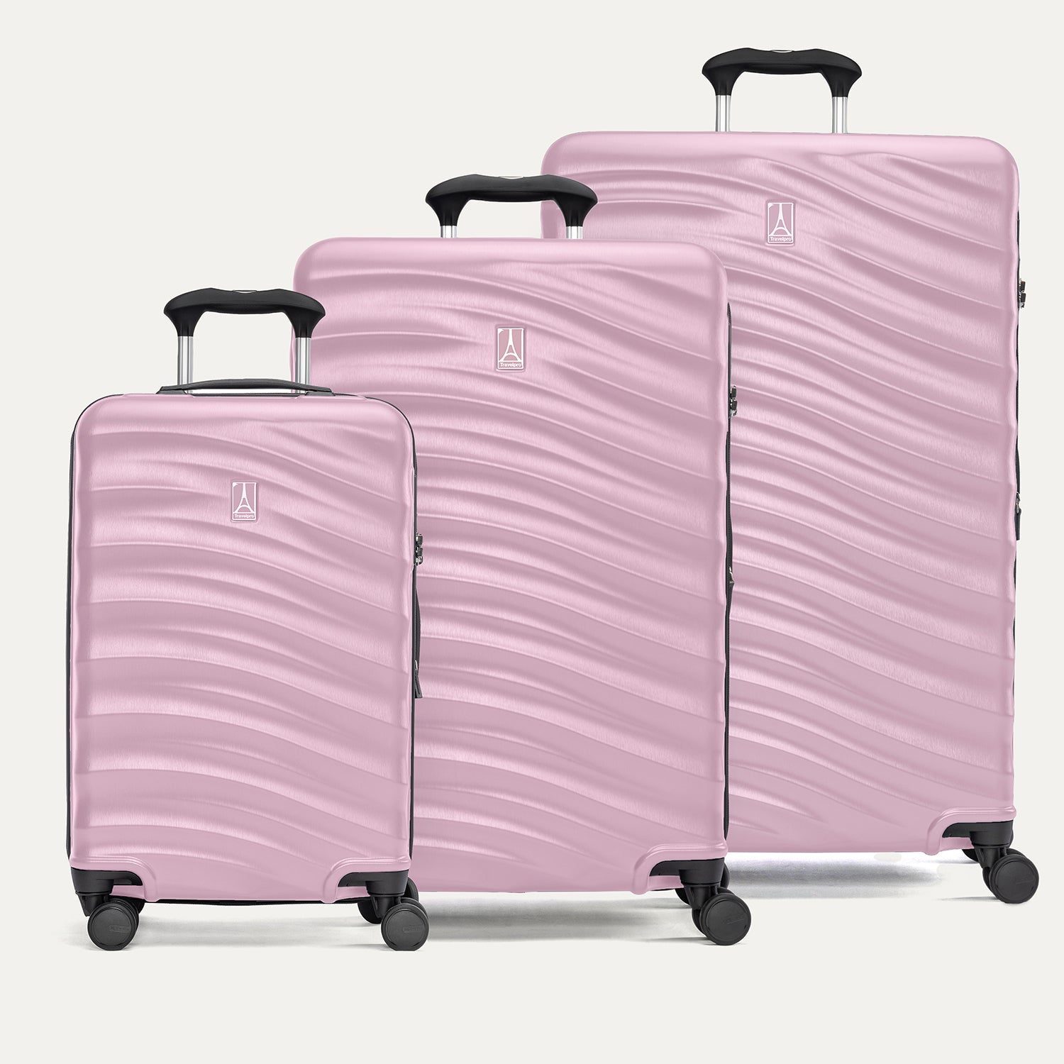A set of three pink hardside spinner suitcases, including carry-on, medium, and large sizes on a white background