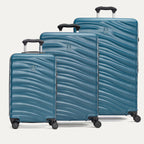 A set of three blue Maxlite Air V2 hardside spinner suitcases, including carry-on, medium, and large sizes, aligned in a row with the large suitcase at the back.