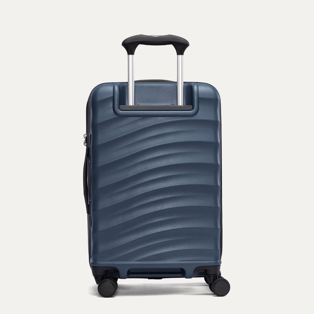 Rear view of Travelpro Maxlite Air V2 Expandable Spinner in Midnight Blue, featuring extended handle and ripple-textured shell.
