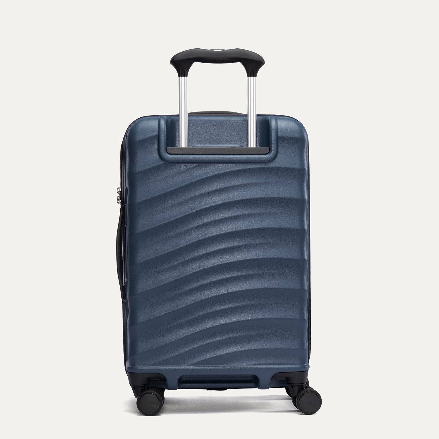 Rear view of Travelpro Maxlite Air V2 Expandable Spinner in Midnight Blue, featuring extended handle and ripple-textured shell.

