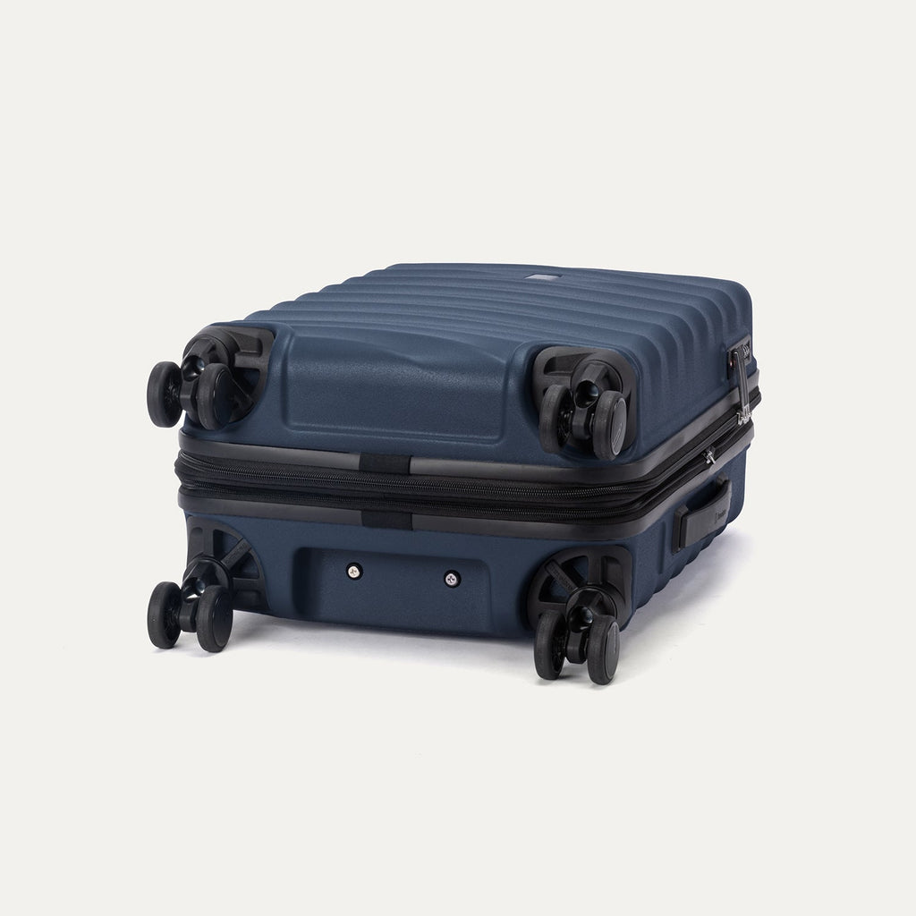 Bottom view of Travelpro Maxlite Air V2 Spinner in Midnight Blue, showing 360° Spinner Wheels and molded base.
