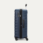 Side view of Travelpro Maxlite Air V2 Expandable Spinner in Midnight Blue, showing TSA Approved Locks and low-profile carry handle.
