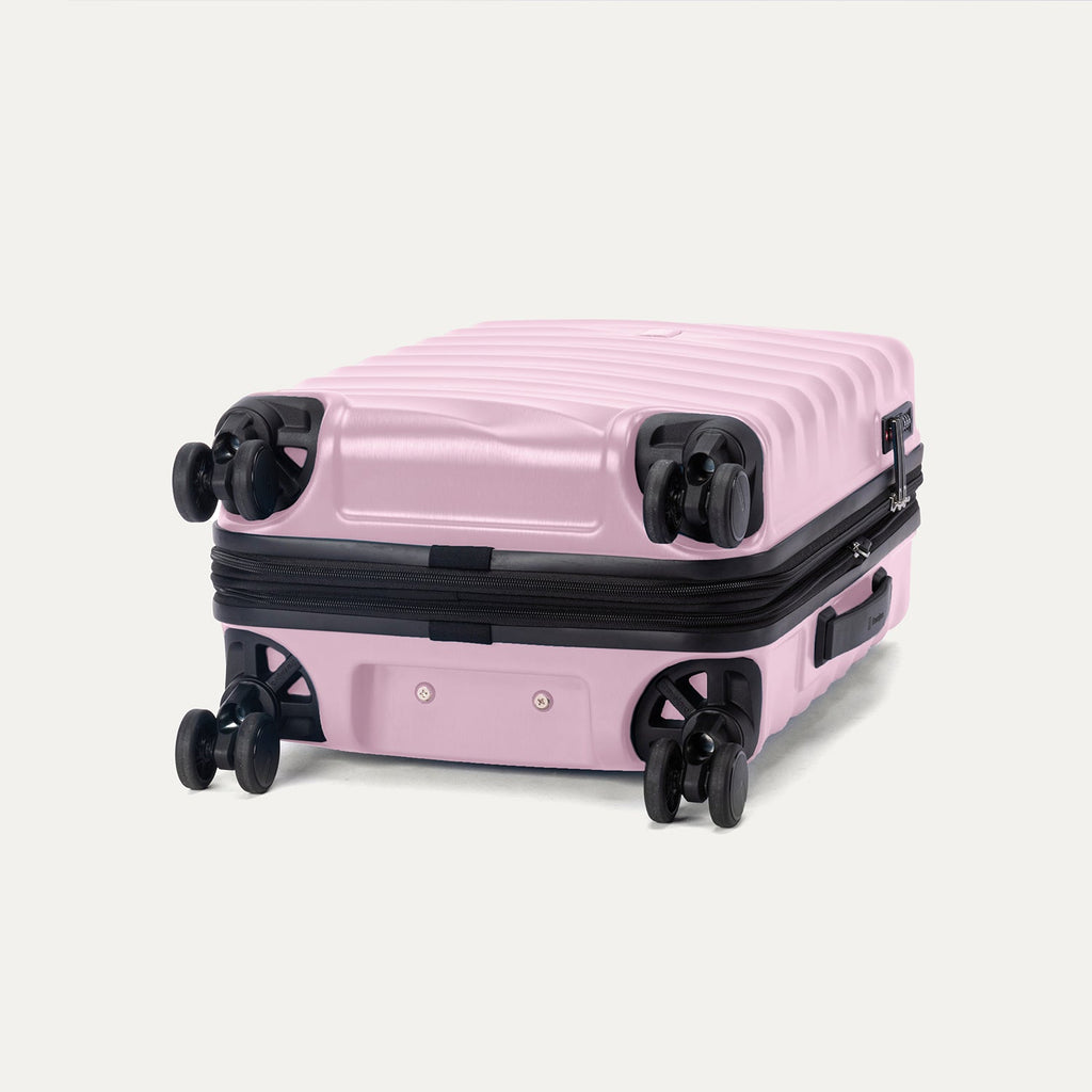 Bottom view of the Travelpro Maxlite Air V2 Spinner in Forever Pink, showing dual-wheel design and textured shell.
