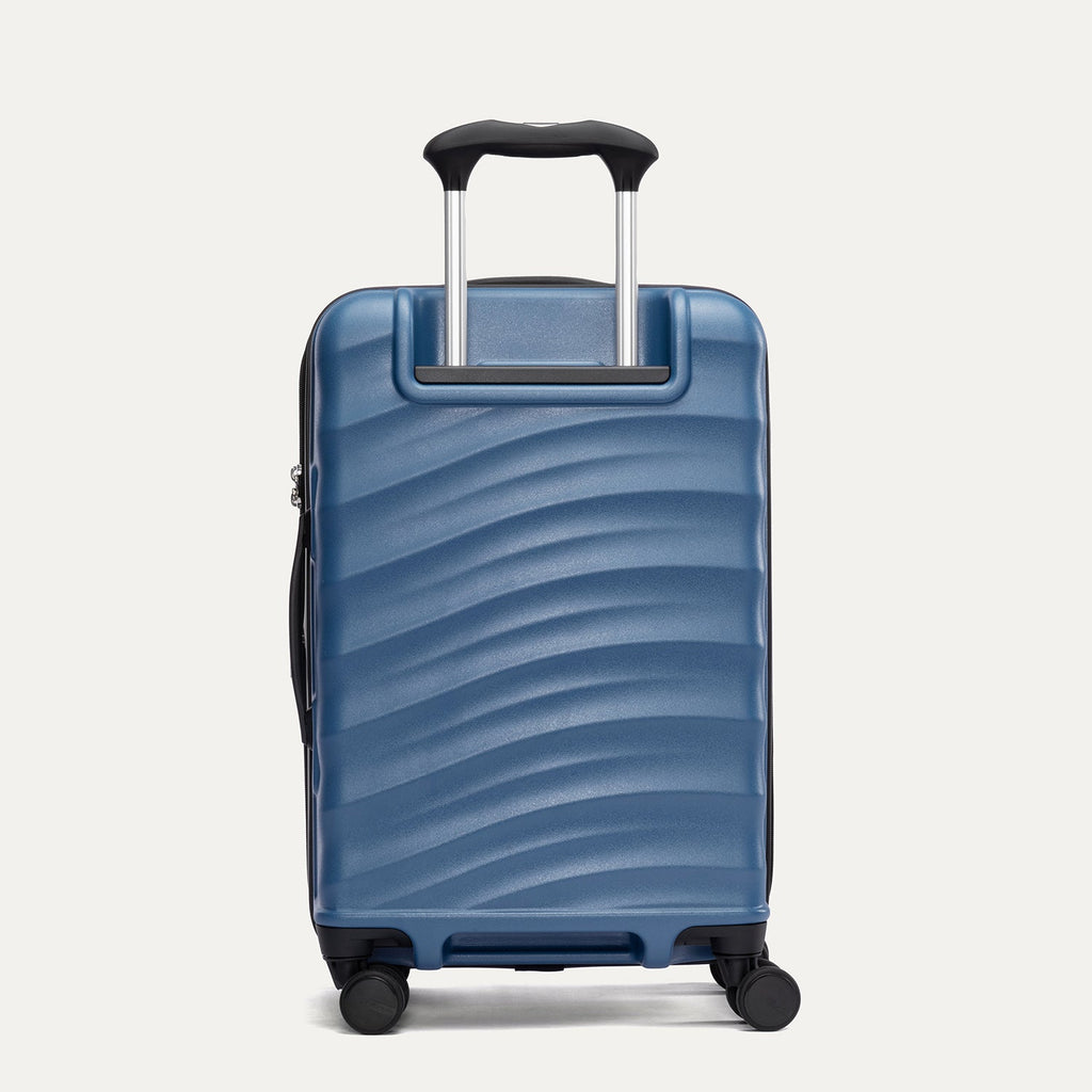 Rear view of Travelpro Maxlite Air V2 Expandable Spinner in Ensign Blue, showing extended handle and ripple-textured shell.

