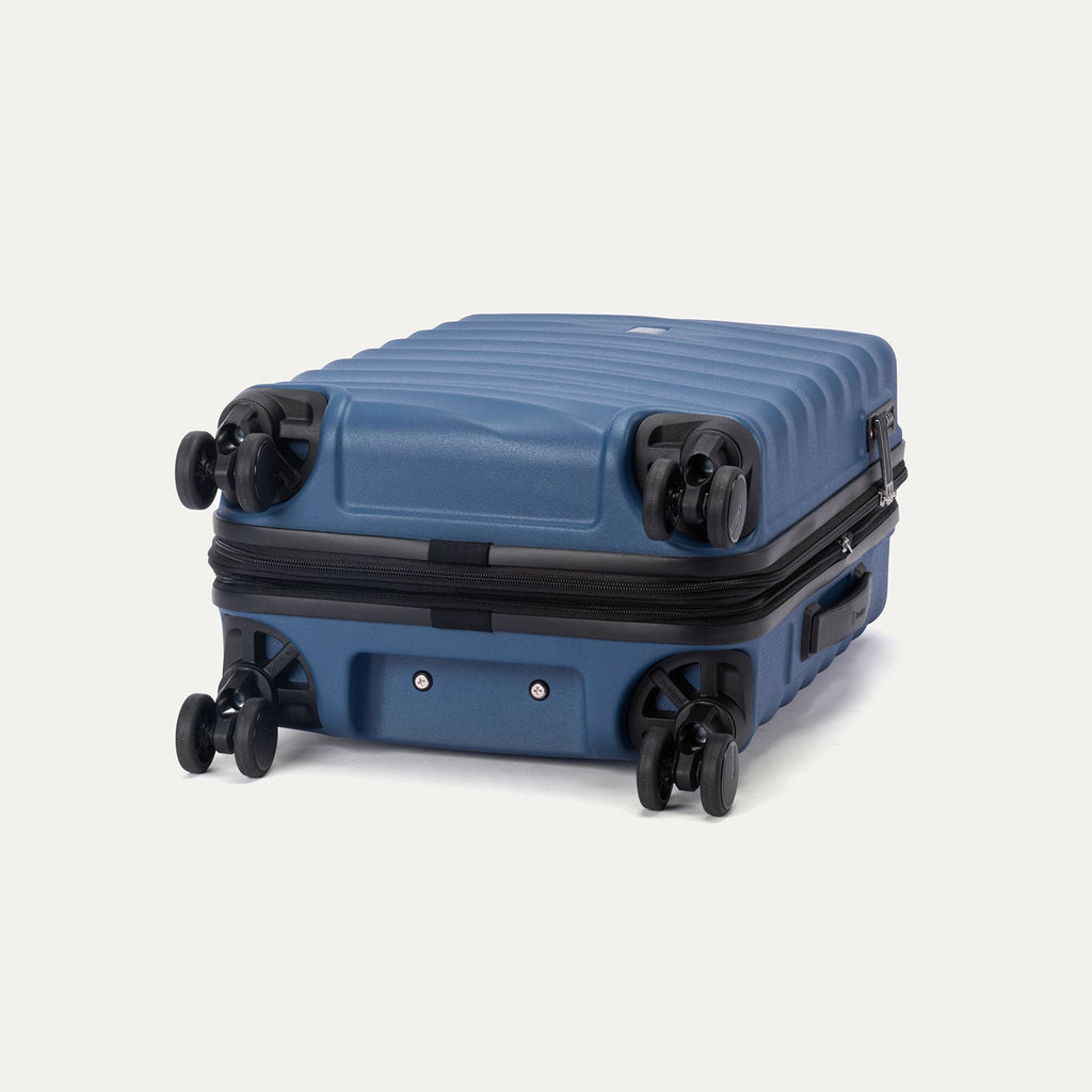 Bottom view of Travelpro Maxlite Air V2 Spinner in Ensign Blue, featuring 360° Spinner Wheels and low-profile bottom carry handle.
