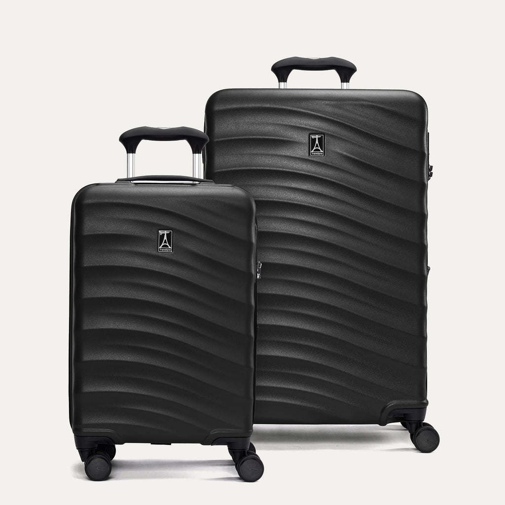 Two black hardside suitcases with a visible brand logo on a light gray background