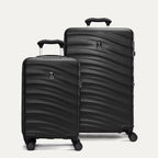 Two black hardside suitcases with a visible brand logo on a light gray background