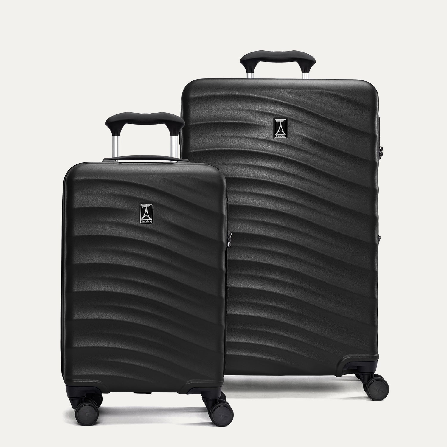 Two black hardside suitcases with a visible brand logo on a light gray background