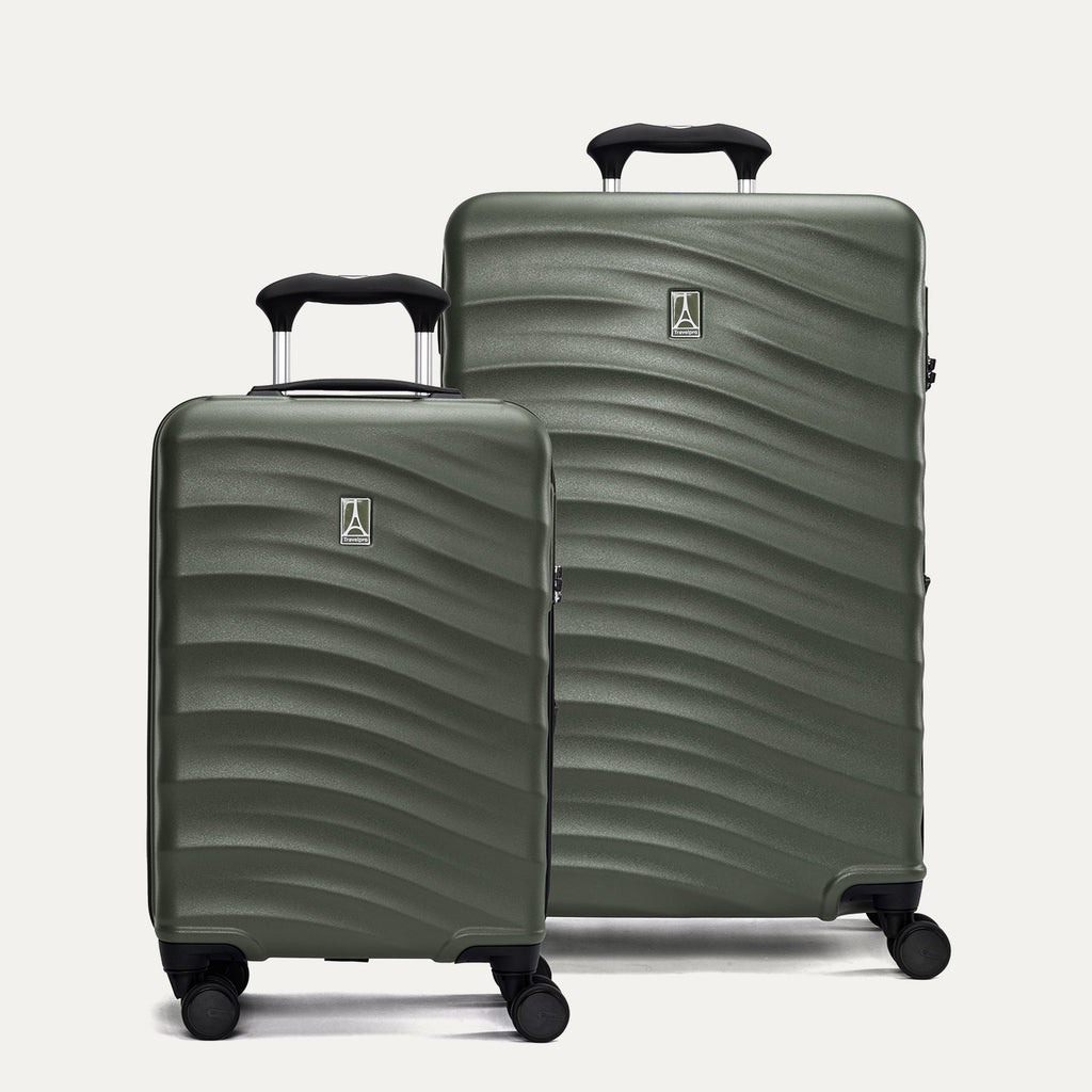 Two green hardside suitcases with a visible brand logo on a light gray background