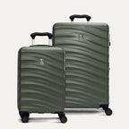 Two green hardside suitcases with a visible brand logo on a light gray background