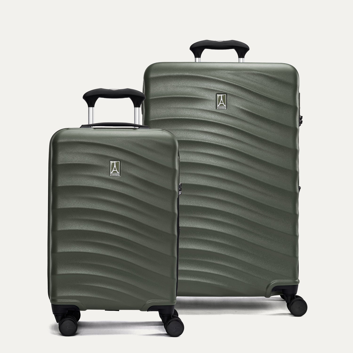 Two green hardside suitcases with a visible brand logo on a light gray background