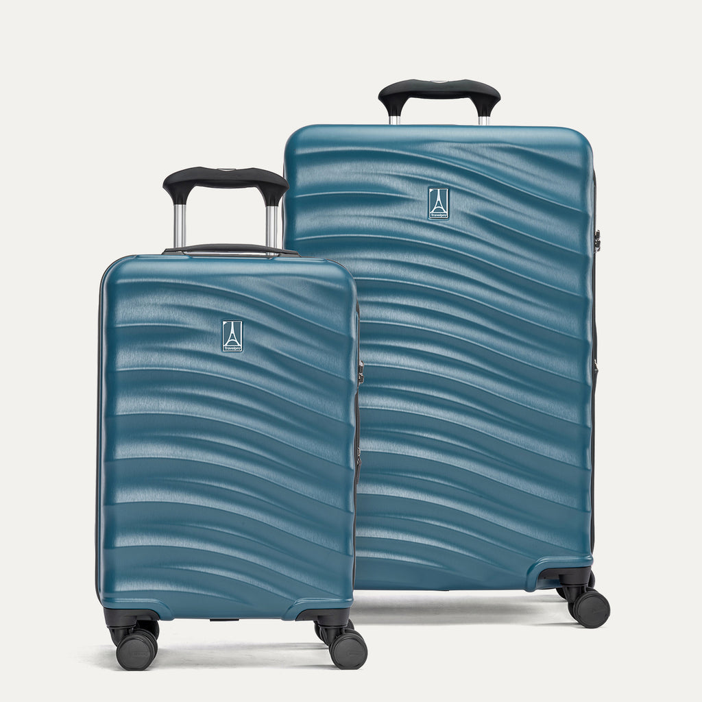 Two blue hardside suitcases with a visible brand logo on a light gray background