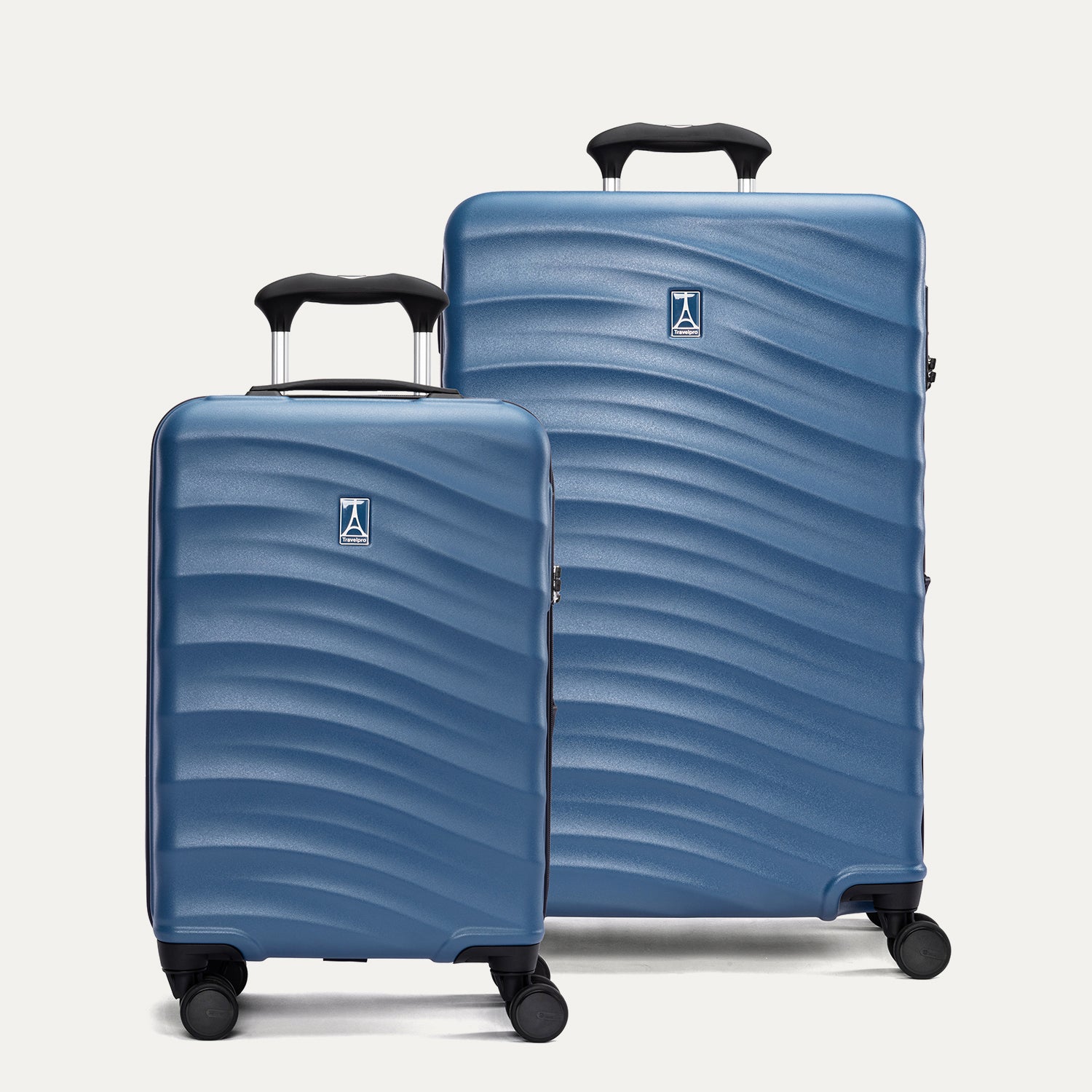 Two blue hardside suitcases with a visible brand logo on a light gray background