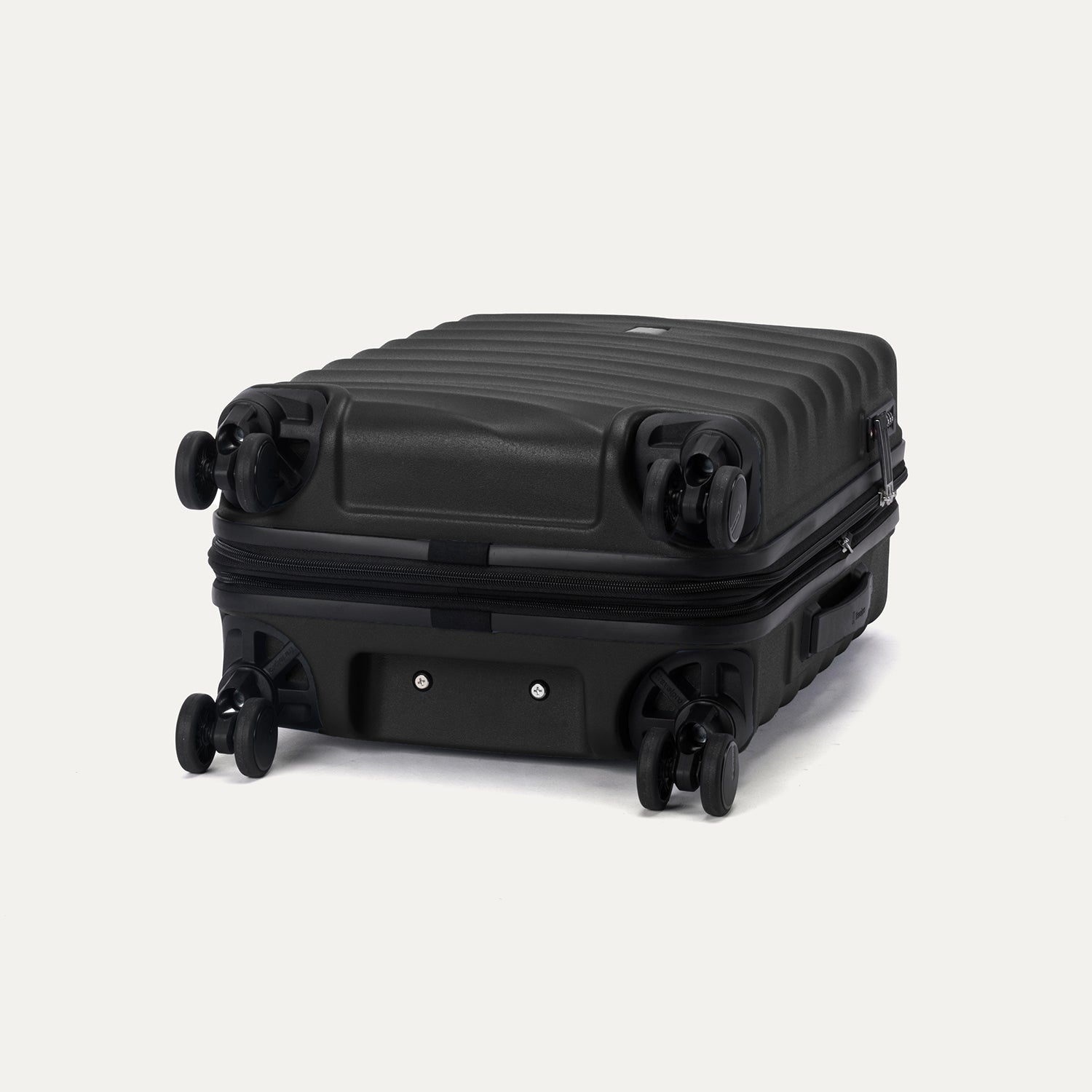 Bottom view of Travelpro Maxlite Air V2 Hardside Spinner in Black, featuring 360° Spinner Wheels and expandable zipper.