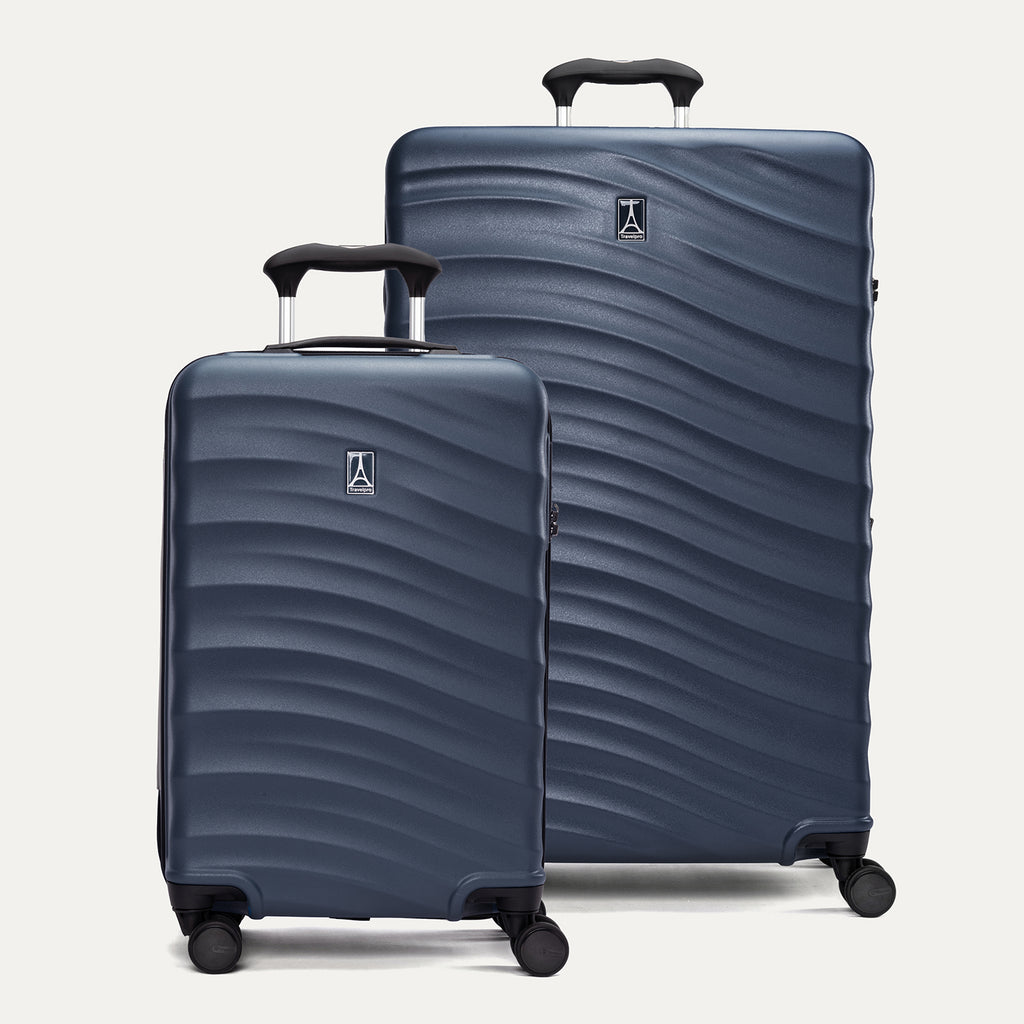 A set of two blue hardside spinner suitcases, one carry-on size and one large check-in size, with a textured surface, integrated handles, and wheels.