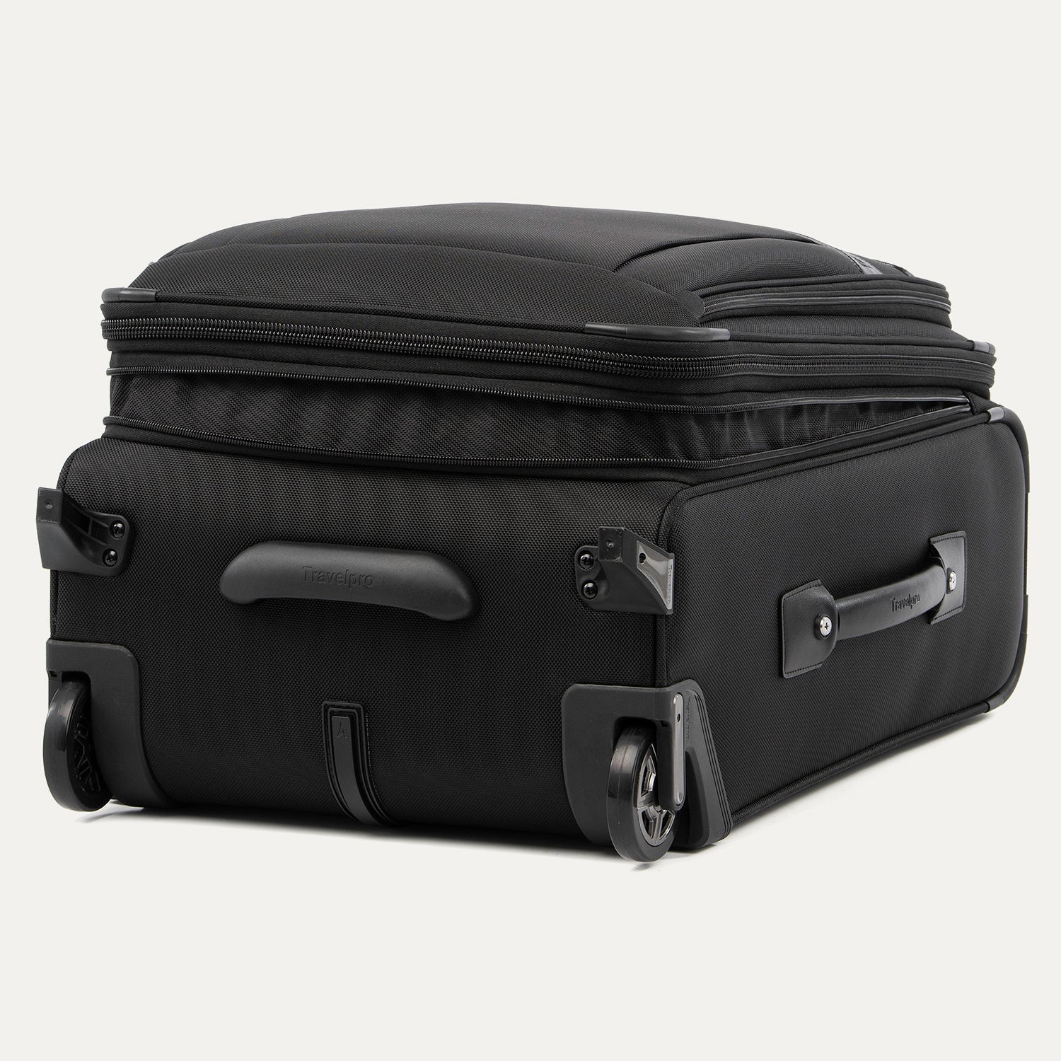 Black suitcase  laying down expanded with wheels on a white background
