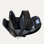 Black backpack with open front compartment on a light gray background