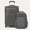 Gray suitcase and backpack set on a light gray background
