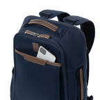 close-up front view of the monaco blue travelpro x travel plus leisure slim backpack, highlighting a convenient top-loading zippered quick-access pocket featuring elegant brown leather trim with a smartphone partially tucked inside, showcasing the durable textured blue fabric construction.