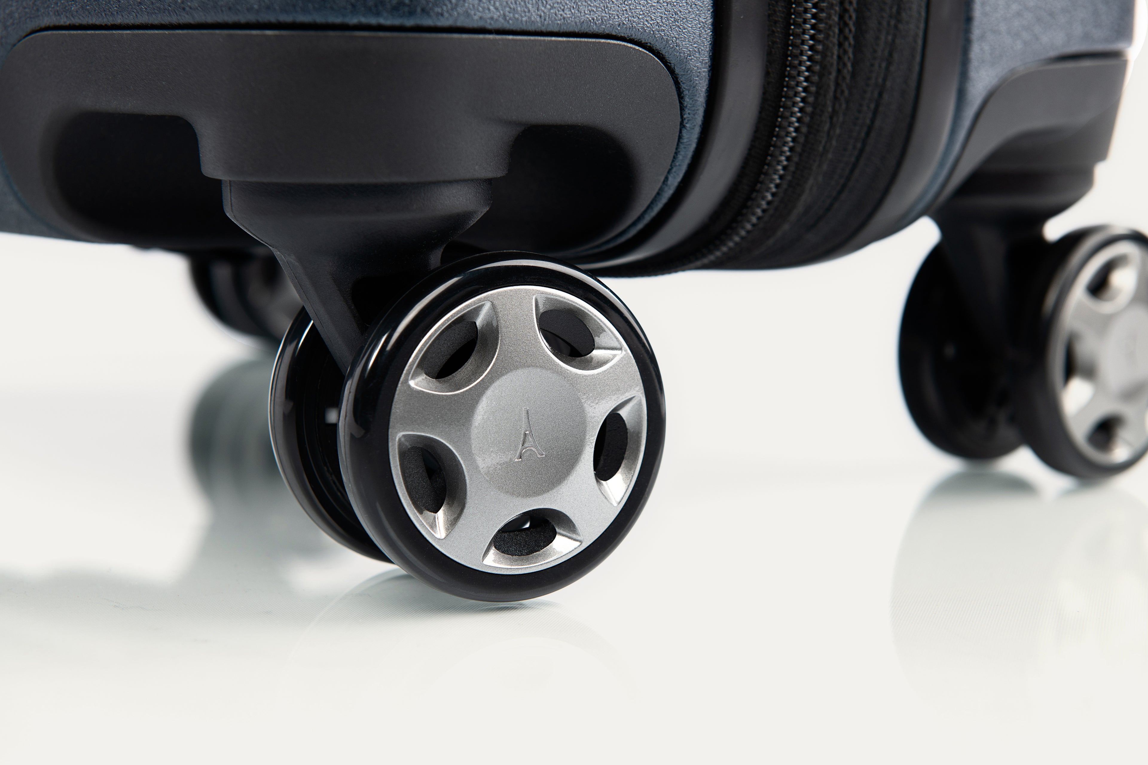 Close-up of a suitcase wheel on a white background