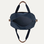 Blue handbag with brown handles and zippers on a white background