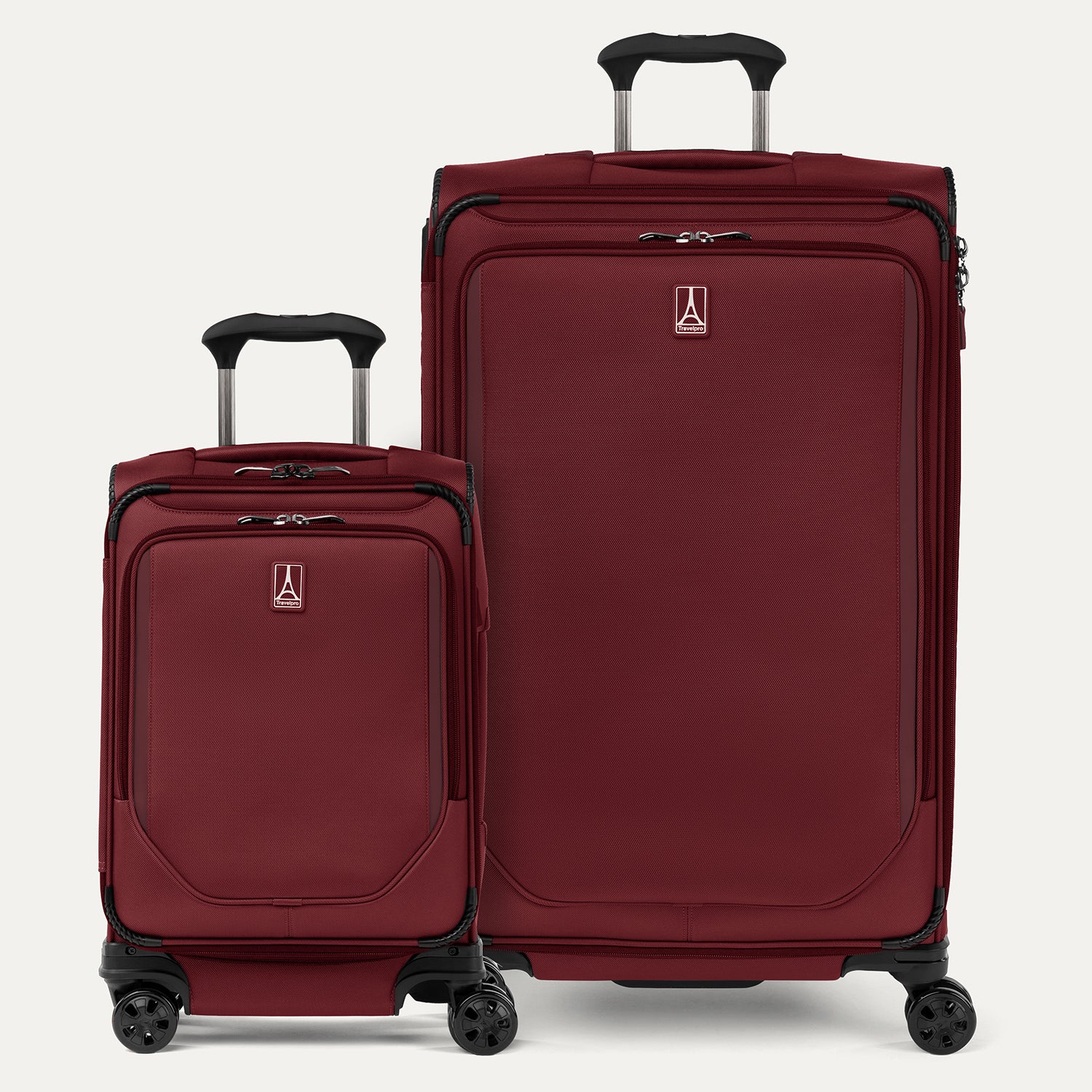 A set of two red spinner suitcases, one carry-on and one large check-in size, with the travelpro logo visible on them.