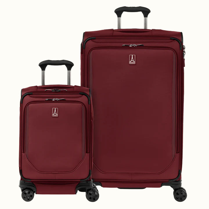 A set of two red spinner suitcases, one carry-on and one large check-in size, with the travelpro logo visible on them.
