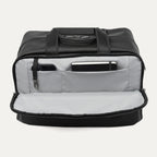 Black tote bag with interior compartments showing a phone and notepad on a white background
