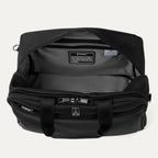 Interior of black tote bag with visible brand logos on a light gray background