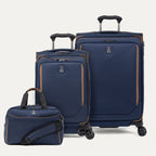 Set of three navy blue suitcases with brown accents on a light gray background