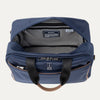 Blue tote bag with open front compartment on a light gray background