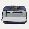 Blue tote bag showing front open compartment  with phone and notepad on a light gray background