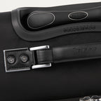 Close-up of a black suitcase handle with visible branding.
