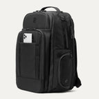 Black backpack with QuickSlip™ pocket holding a phone, on a white background