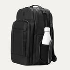 Black backpack with a white bottle inside on a white background