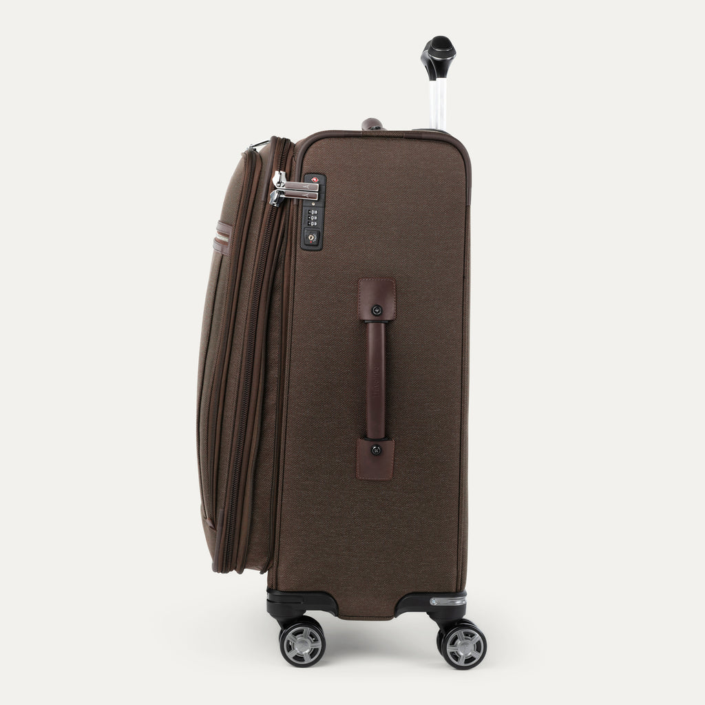 Side view of brown suitcase with wheels and handle on a white background