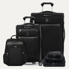Set of black suitcases and backpack on a light gray background