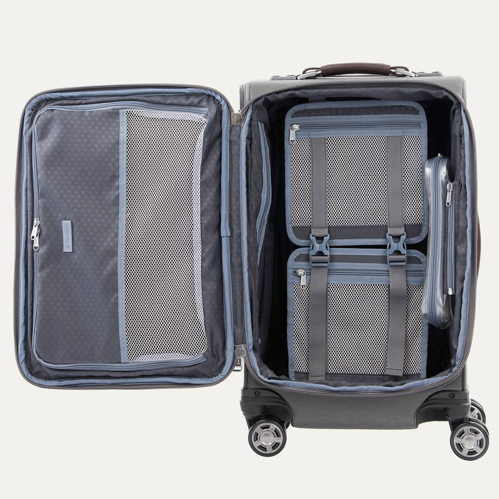 Open gray suitcase with interior organization panels on a white background