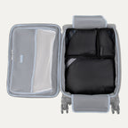 Gray suitcase with open compartment showing black packing cubes and mesh pocket on a light gray background