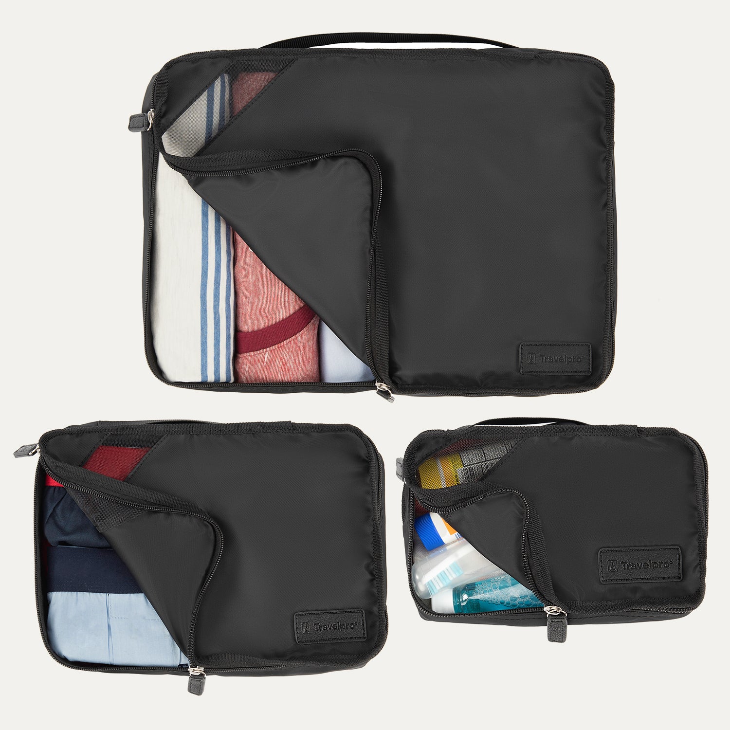 3 black travel packing cubes with clothes and toiletries on a white background