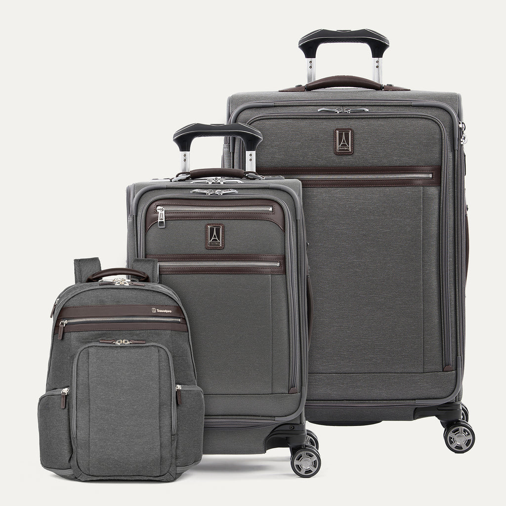 Set of gray suitcases with wheels  and a backpack on a white background